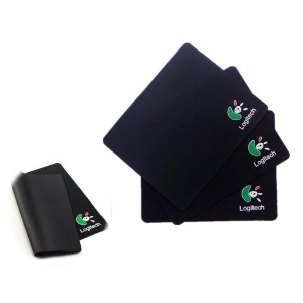 Four black Logitech mouse pads with the green and white Logitech logo, shown on a plain white background with one pad folded over on the left.