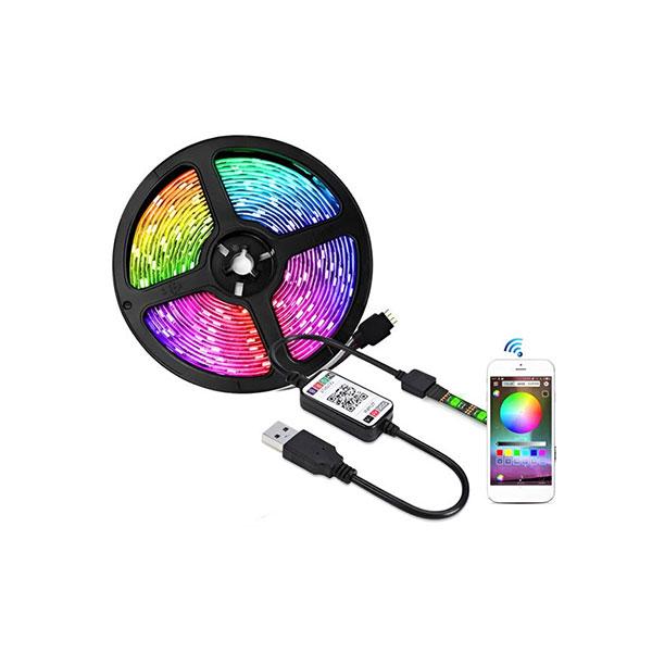 A coiled RGB LED light strip with a USB connector, a small control box, and a smartphone showing a color display app, all on a plain white background.