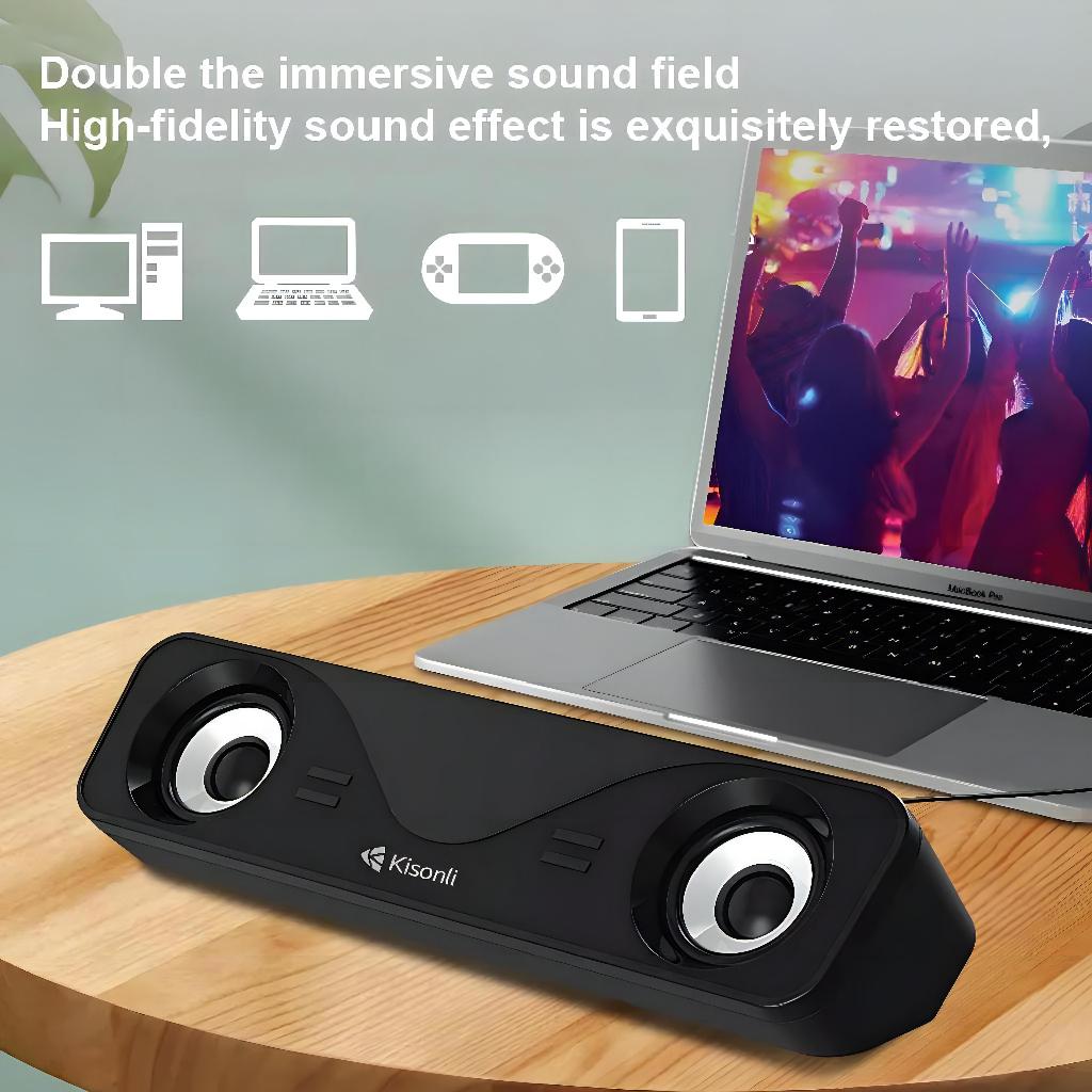 Black speaker on a wooden surface with a laptop displaying a concert scene, text about immersive sound field.