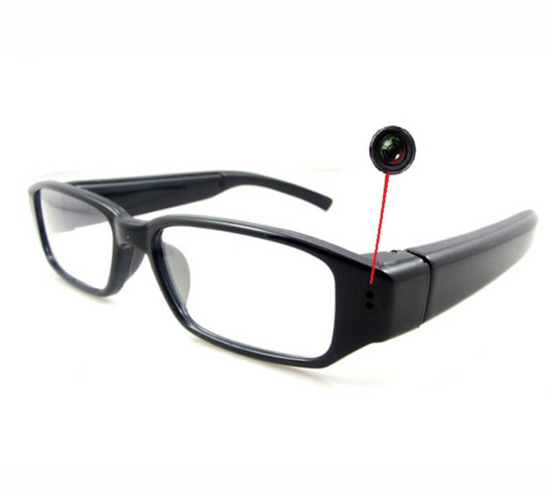 Front view of full hd 1080p spy glasses hidden camera in matte black frame
Side temple arm of spy camera glasses showing hidden single touch control button
Close up shot of the invisible micro pinhole lens on camera glasses
Full hd 1080p spy camera glasses shown with protective carrying case and usb cable
Person wearing full hd spy glasses capturing point of view video hands free